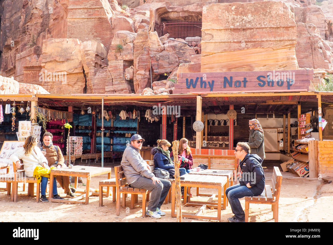 Tourists resting and having refreshments in an al fresco area of a restaurant in Petra, Jordan. Stock Photo