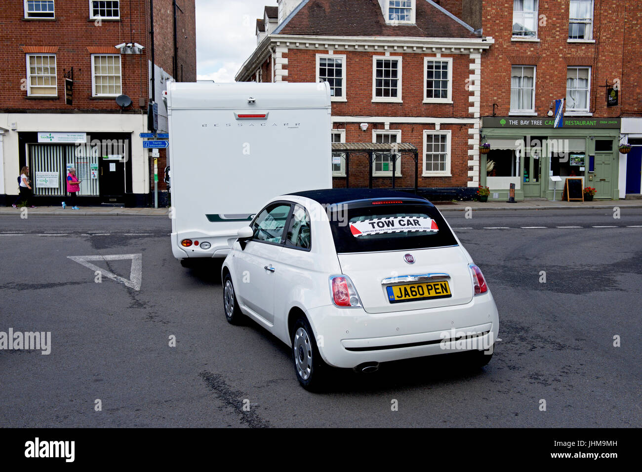 Motorhome towing small car in Tewkesbury, Gloucestershire, England UK