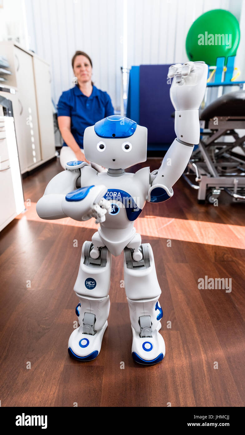 Physiotherapist Stefanie Finn watches the robot Zora in a therapy room at  the Karl Lennert Cancer Centre in Kiel, Germany, 14 July 2017. Zora is the  first humanoid robot to be put
