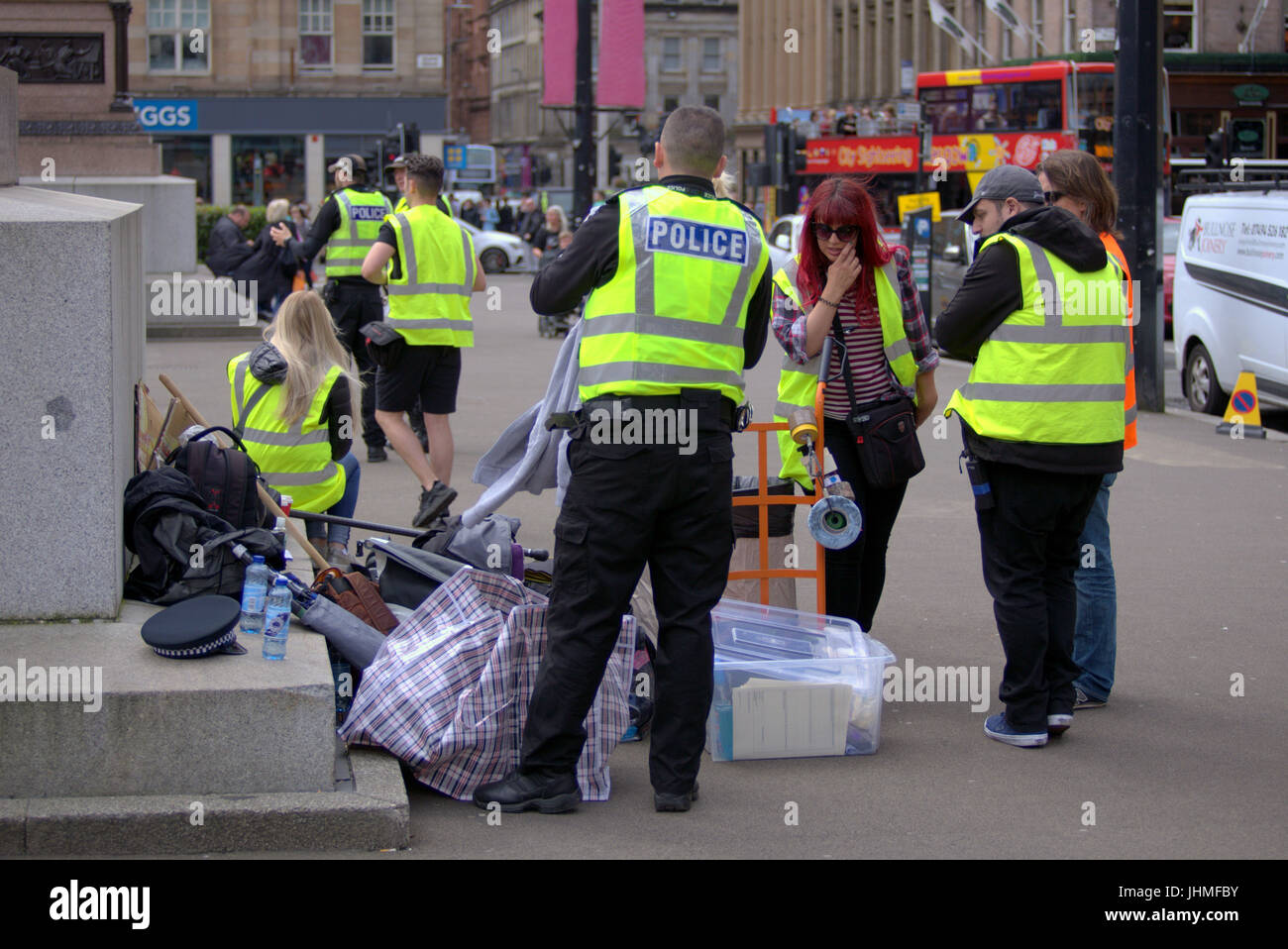 Glasgow, Scotland, UK. 14th July. Filming was nonchalantly ignored today by locals now getting used to media and film crews in the city as people passed their lunchtime with the latest series of  the BBC Scotland spoof police comedy “Scot squad” was being shot in the city's George Square, Credit: gerard ferry/Alamy Live News Stock Photo