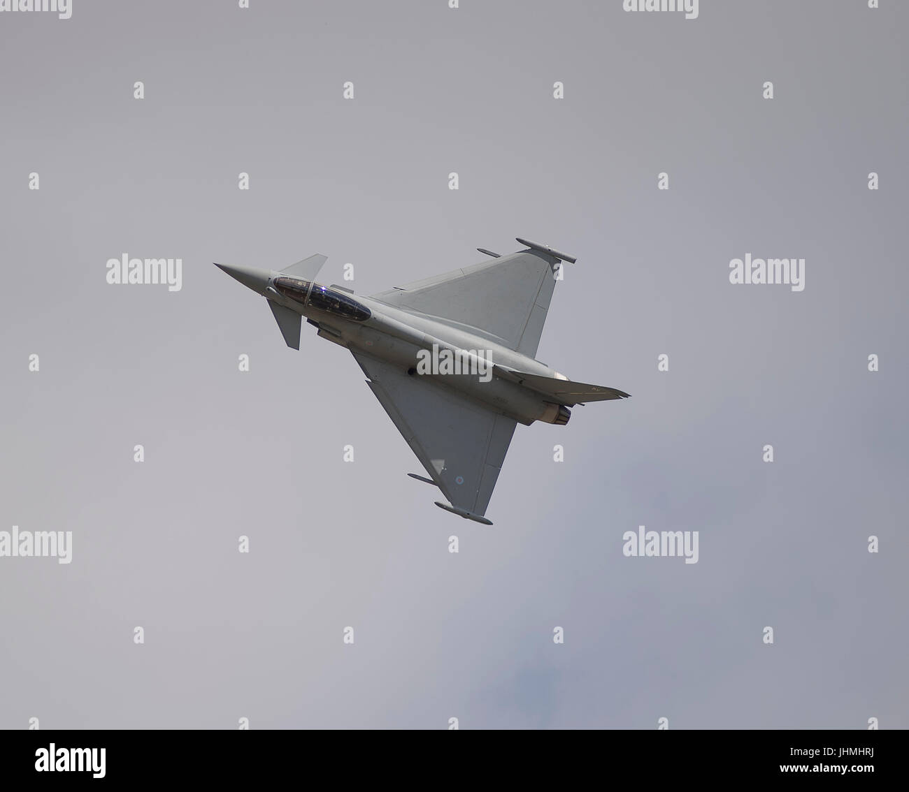 RAF Fairford, Gloucestershire, UK. 14th July 2017. First day of the Royal International Air Tattoo (RIAT), one of the world’s greatest airshows. Flying displays include the Battle of Britain flight and USAF aircraft celebrating the 70th anniversary of their service. Photo: RAF Eurofighter Typhoon FGR4 flying display against grey cloud. Credit: Malcolm Park / Alamy Live News. Stock Photo