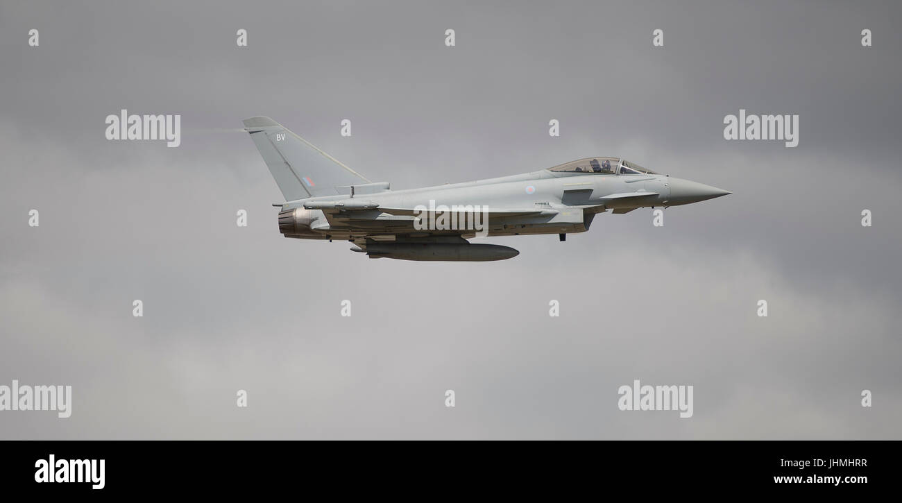 RAF Fairford, Gloucestershire, UK. 14th July 2017. First day of the Royal International Air Tattoo (RIAT), one of the world’s greatest airshows. Flying displays include the Battle of Britain flight and USAF aircraft celebrating the 70th anniversary of their service. Photo: RAF Eurofighter Typhoon FGR4 flying display against grey cloud. Credit: Malcolm Park / Alamy Live News. Stock Photo