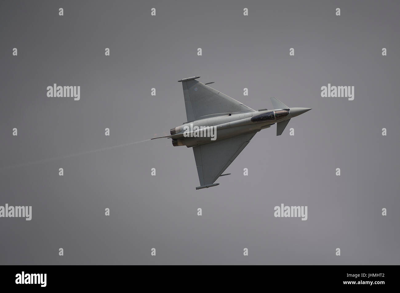 RAF Fairford, Gloucestershire, UK. 14th July 2017. First day of the Royal International Air Tattoo (RIAT), one of the world’s greatest airshows. Flying displays include the Battle of Britain flight and USAF aircraft celebrating the 70th anniversary of their service. Photo: RAF Eurofighter Typhoon FGR4 flying display against grey cloud. Credit: Malcolm Park / Alamy Live News. Stock Photo