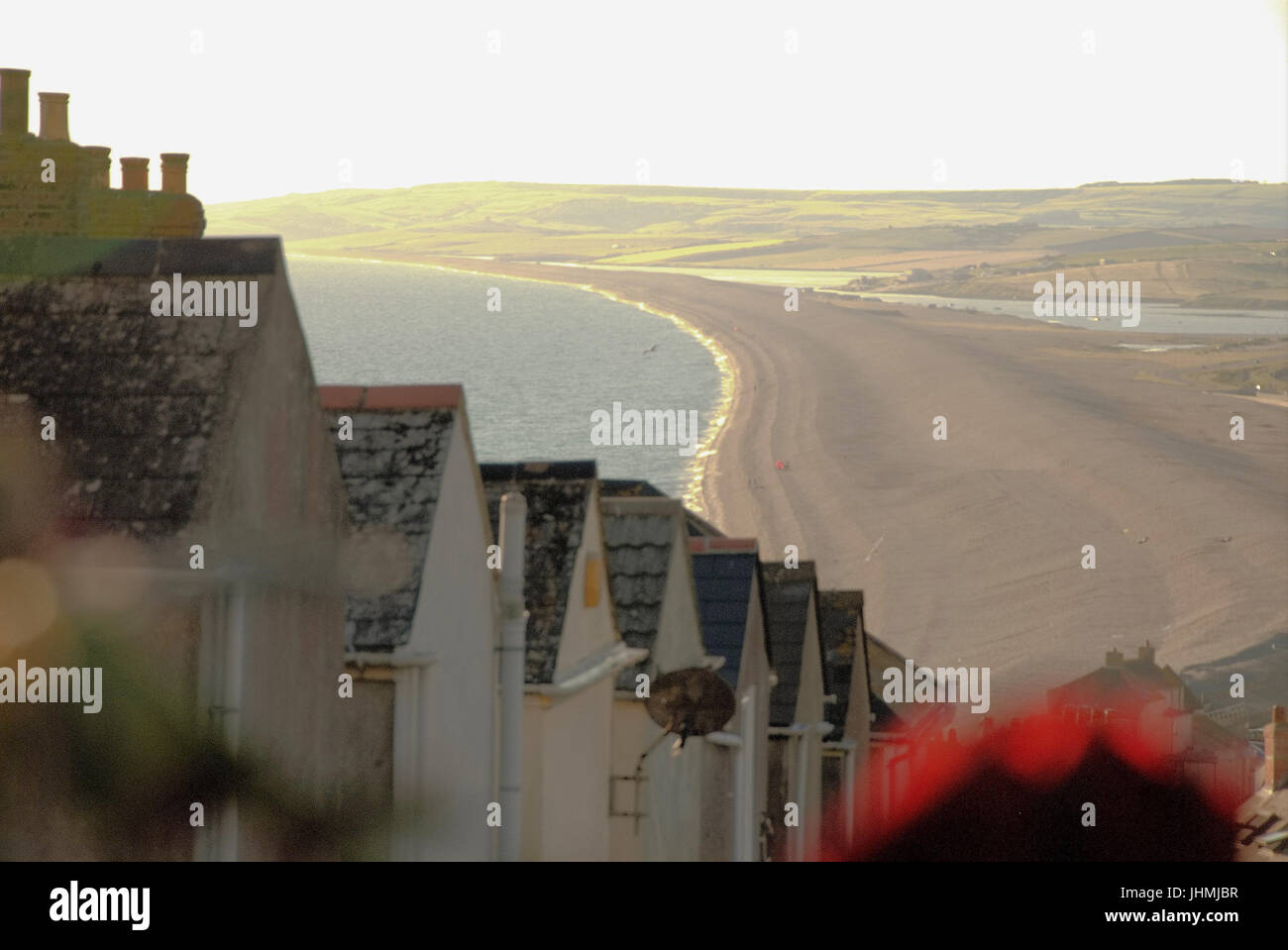 Dorset, UK. 14th July, 2017. Temperatures drop sharply as the last of the day's sunshine rakes across Chesil beach, Portland Credit: stuart fretwell/Alamy Live News Stock Photo