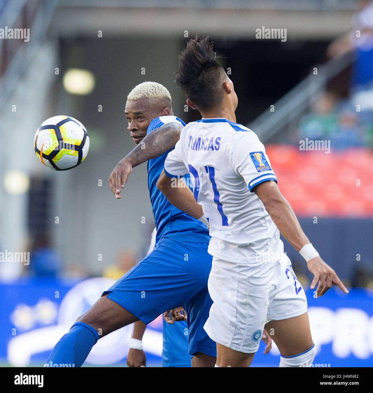 Denver, Colorado, USA. 13th July, 2017. Curacao MF LEANDRO BACUNA, left, battles with El Salvador D BRYAN TAMACAS, right, for control of the ball during the 1st. Half at Sports Authority Field at Mile High during the CONCACAF Gold Cup tournament Thursday night. El Salvador beats Curacao 2-0. Credit: Hector Acevedo/ZUMA Wire/Alamy Live News Stock Photo