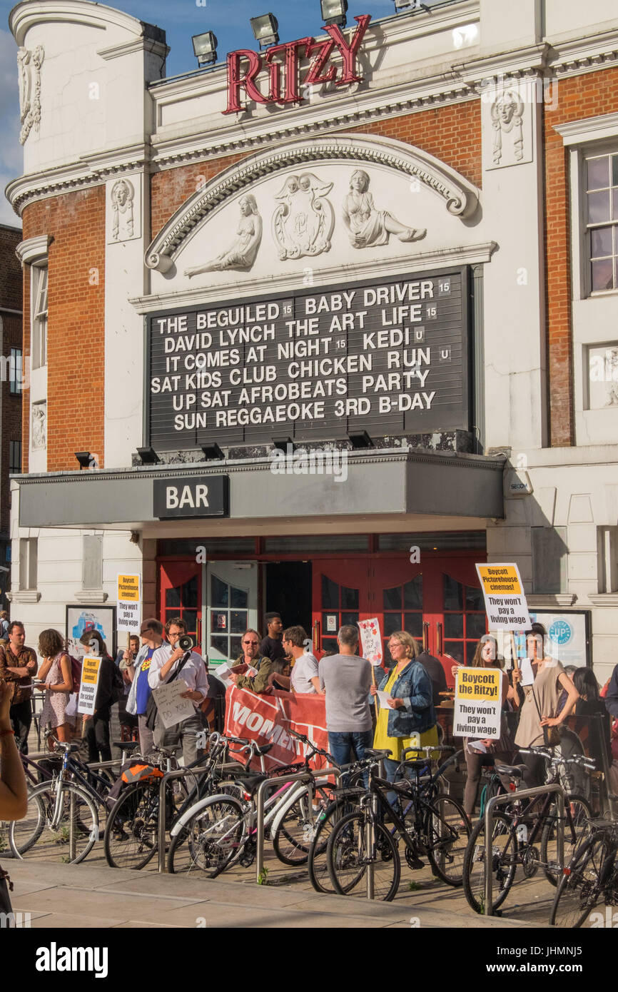 July 14, 2017 - London, UK - London, UK. 14th July 2017. A community protestby local cinema-goers outside Brixton's Ritzy Cinema supports the workers there, calling for people to boycott the cinema and bar along with other cinemas also owned by Picturhouse. Workers at the Ritzy have been campaigning for several years to get the London Living Wage, which is paid by other cinemas. Despite making huge profits, CIneworld, the owners of Picturehouse have not been prepared to pay staff a living wage. Three BECTU union reps at the Ritzy have now been sacked and a fourth is awaiting a disciplinary hea Stock Photo