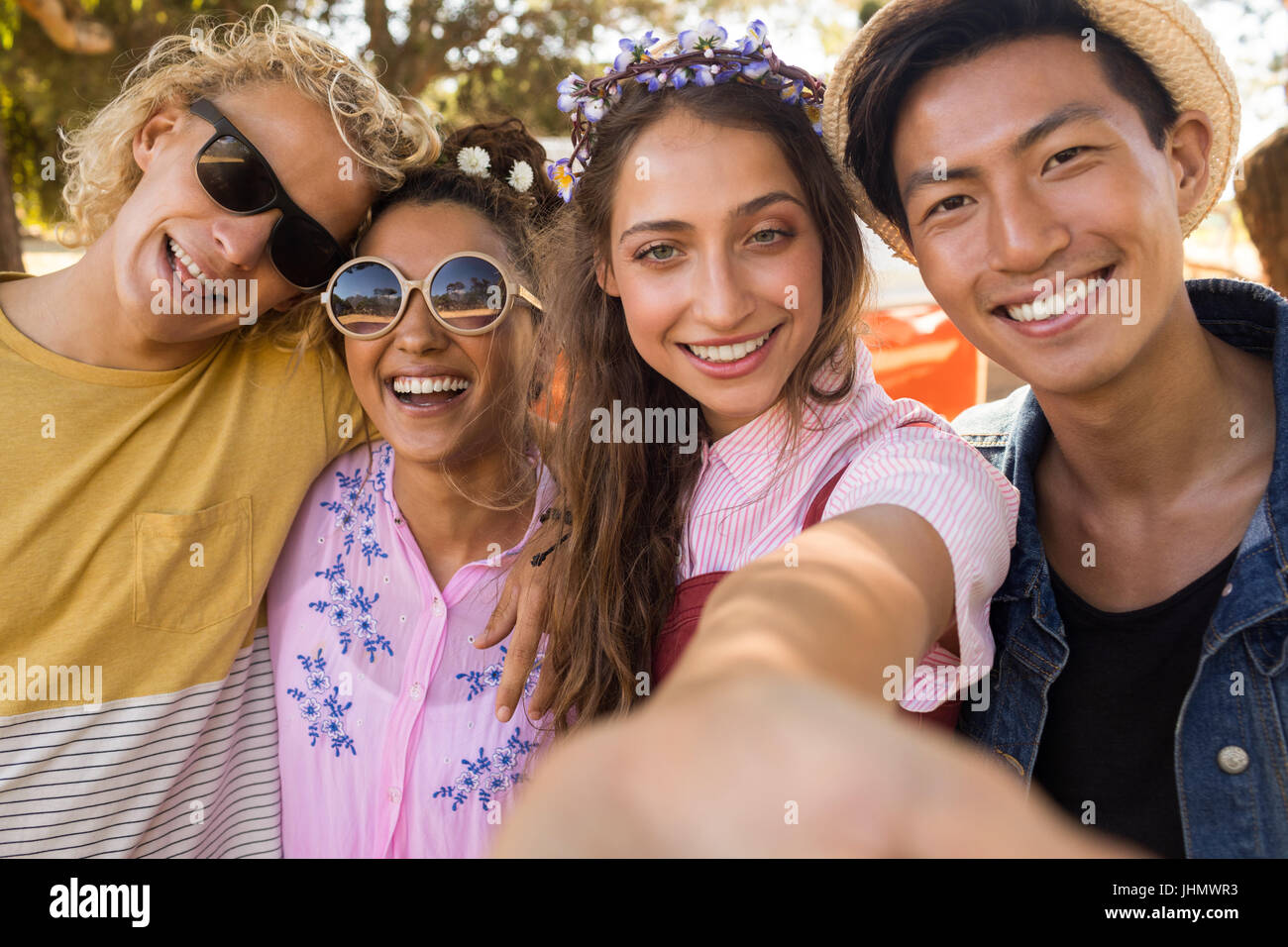 Close up portrait of smiling friends standing side by side Stock Photo