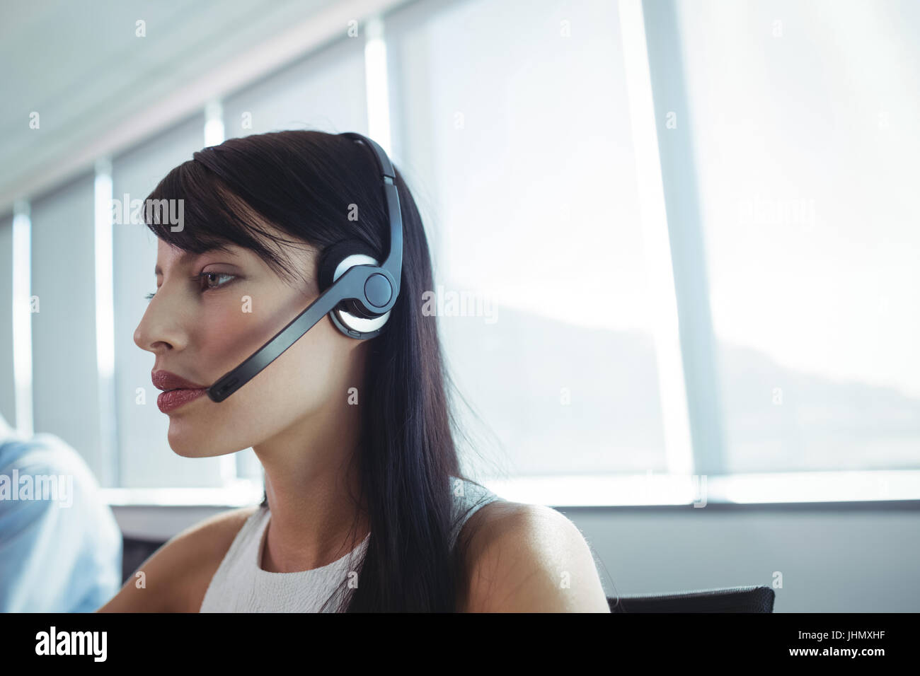 Close up of businesswoman using headset at call center Stock Photo