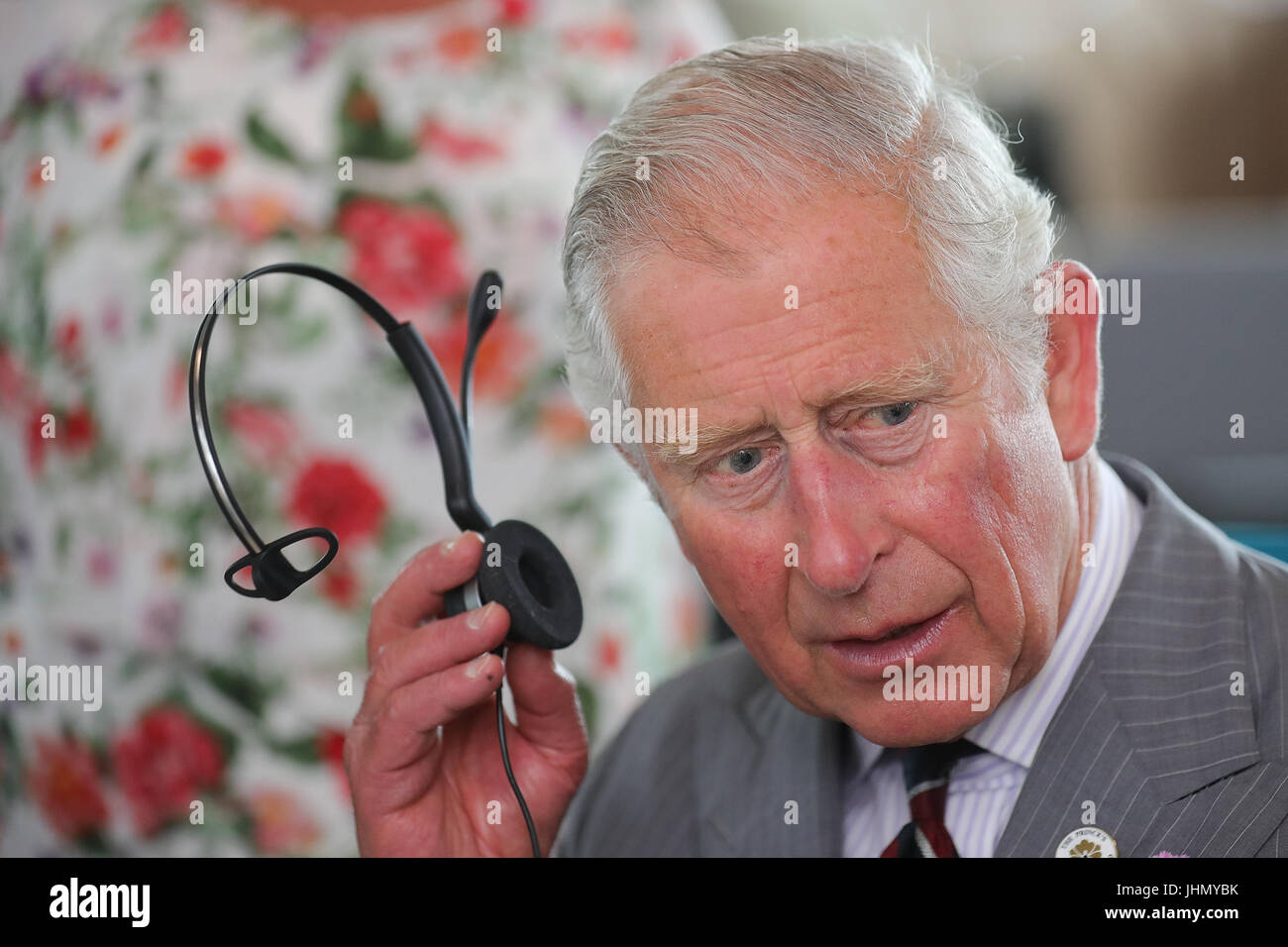 The Prince of Wales listens in to a telephone call after he officially opened the new headquarters of Moneypenny, which looks after telephone calls and outsourced digital switchboard services, in Western Gateway, Wrexham. Stock Photo