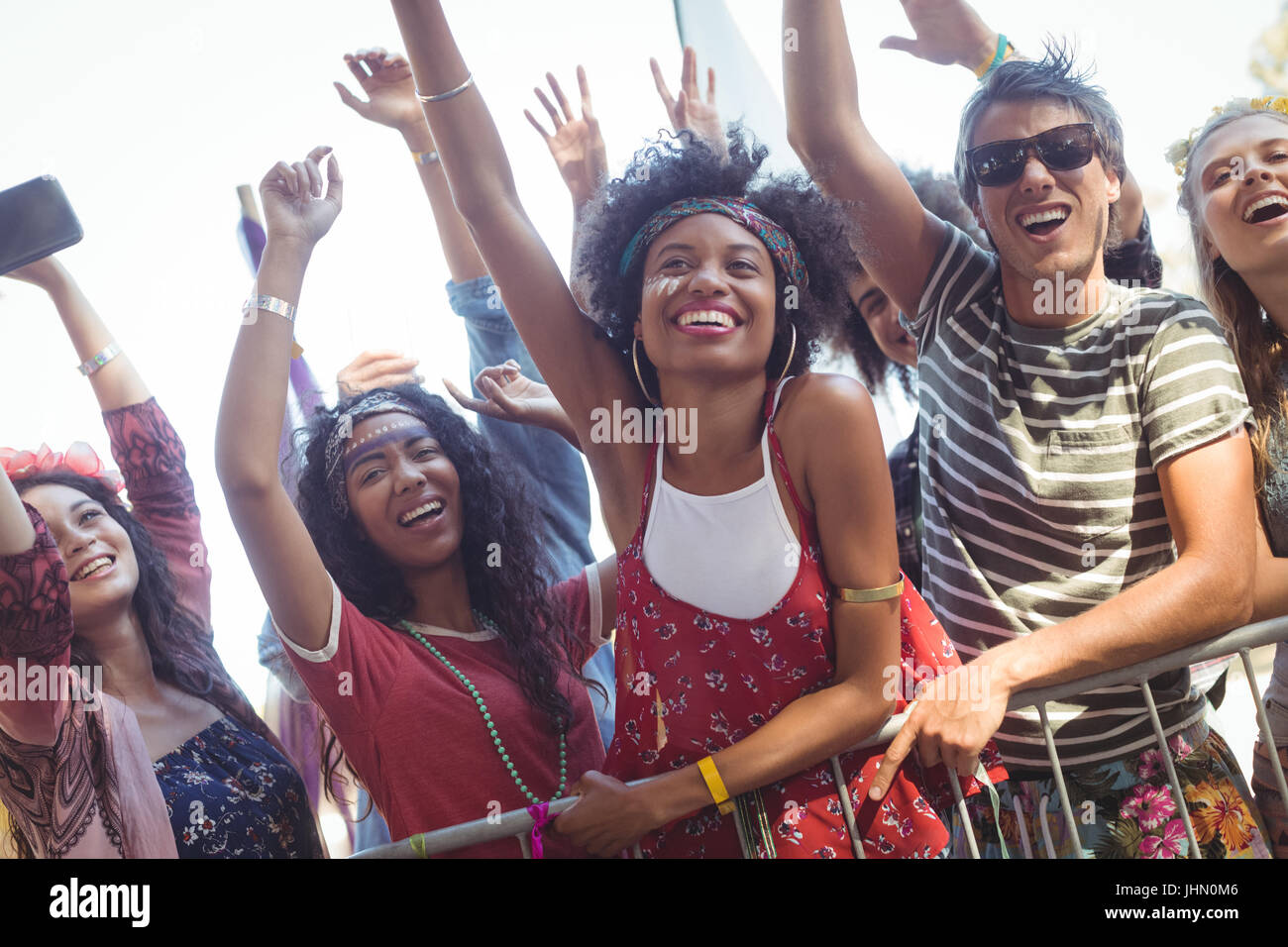 Happy Rocker Friend Cheerful friends by railing enjoying at music festival Stock Photo - Alamy