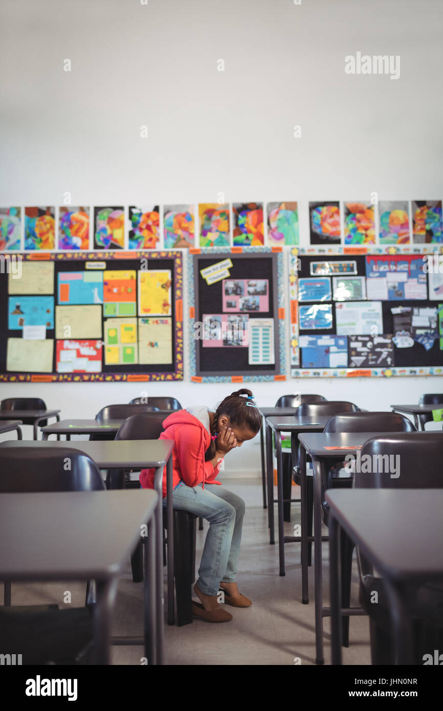 Full length of girl sitting on chair in classroom at school Stock Photo ...