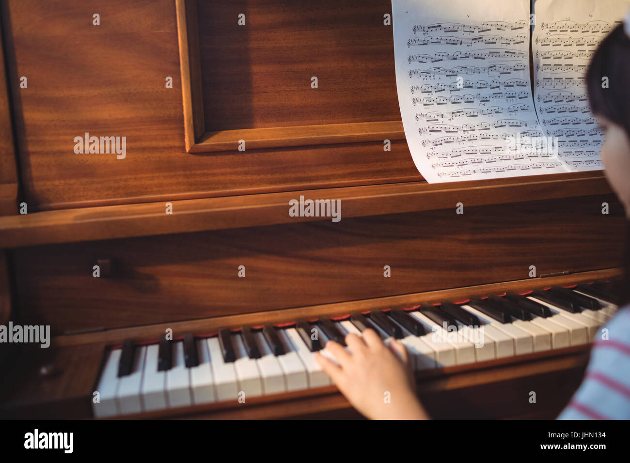 Cropped Image Of Girl Practicing Piano In Classroom At Music School cropped-image-of-girl-practicing-piano-in-classroom-at-music-school