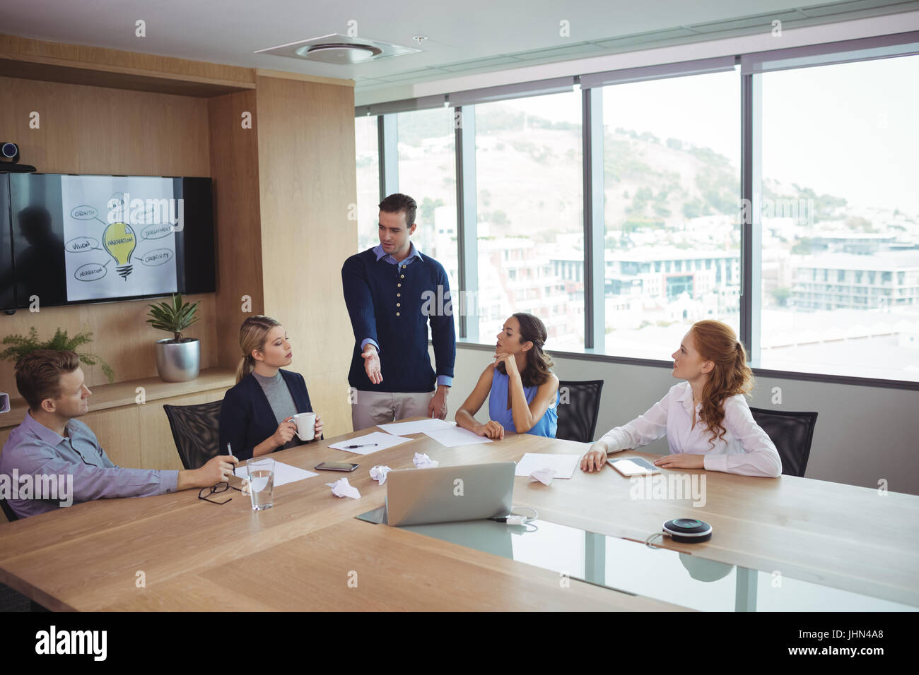 Young business partners discussing in meeting at office board room ...