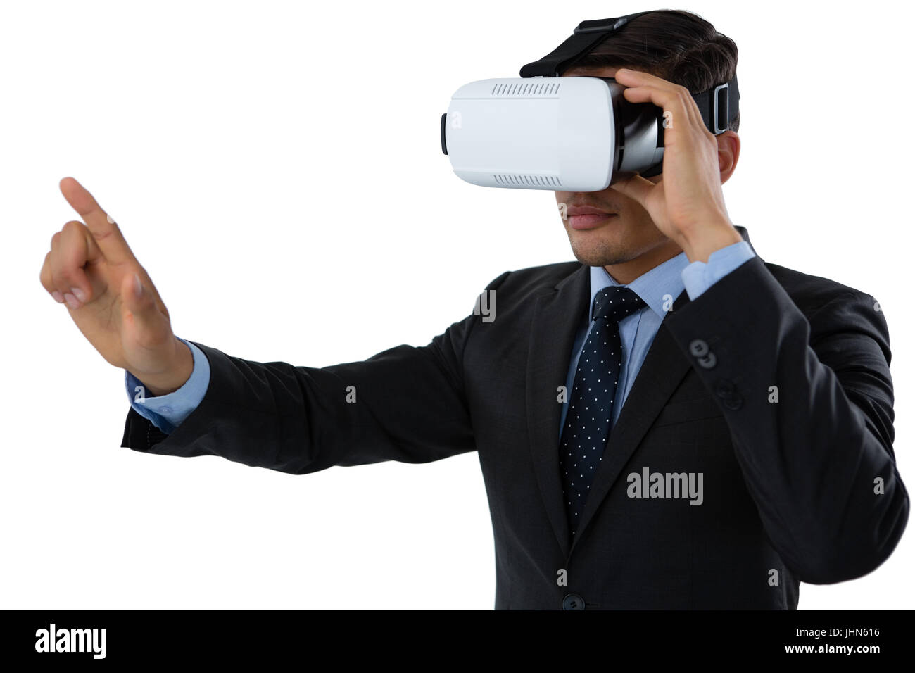 Businessman gesturing while using vr glasses against white background Stock Photo