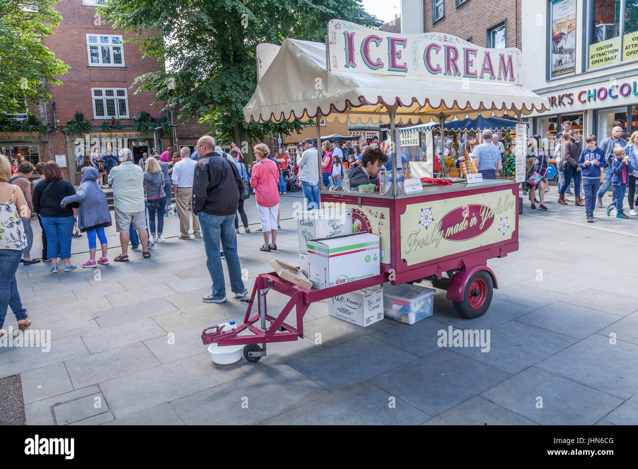 An ice cream vendor in a busy city center in York,England,UK Stock Photo