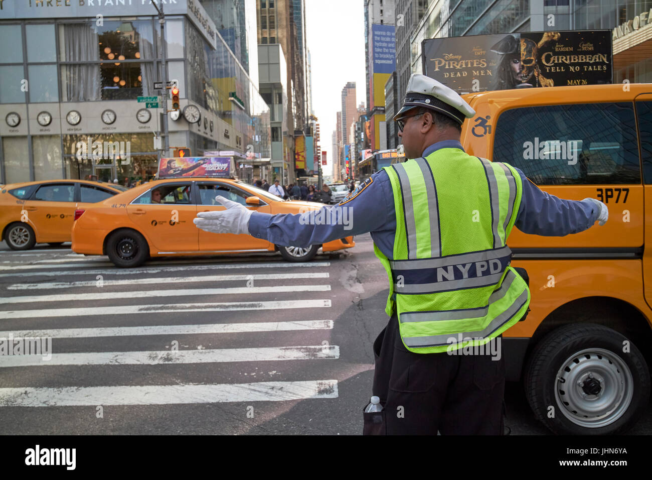 nypd traffic officer with whistle in mouth directing traffic on 6th ave New York City USA Stock Photo