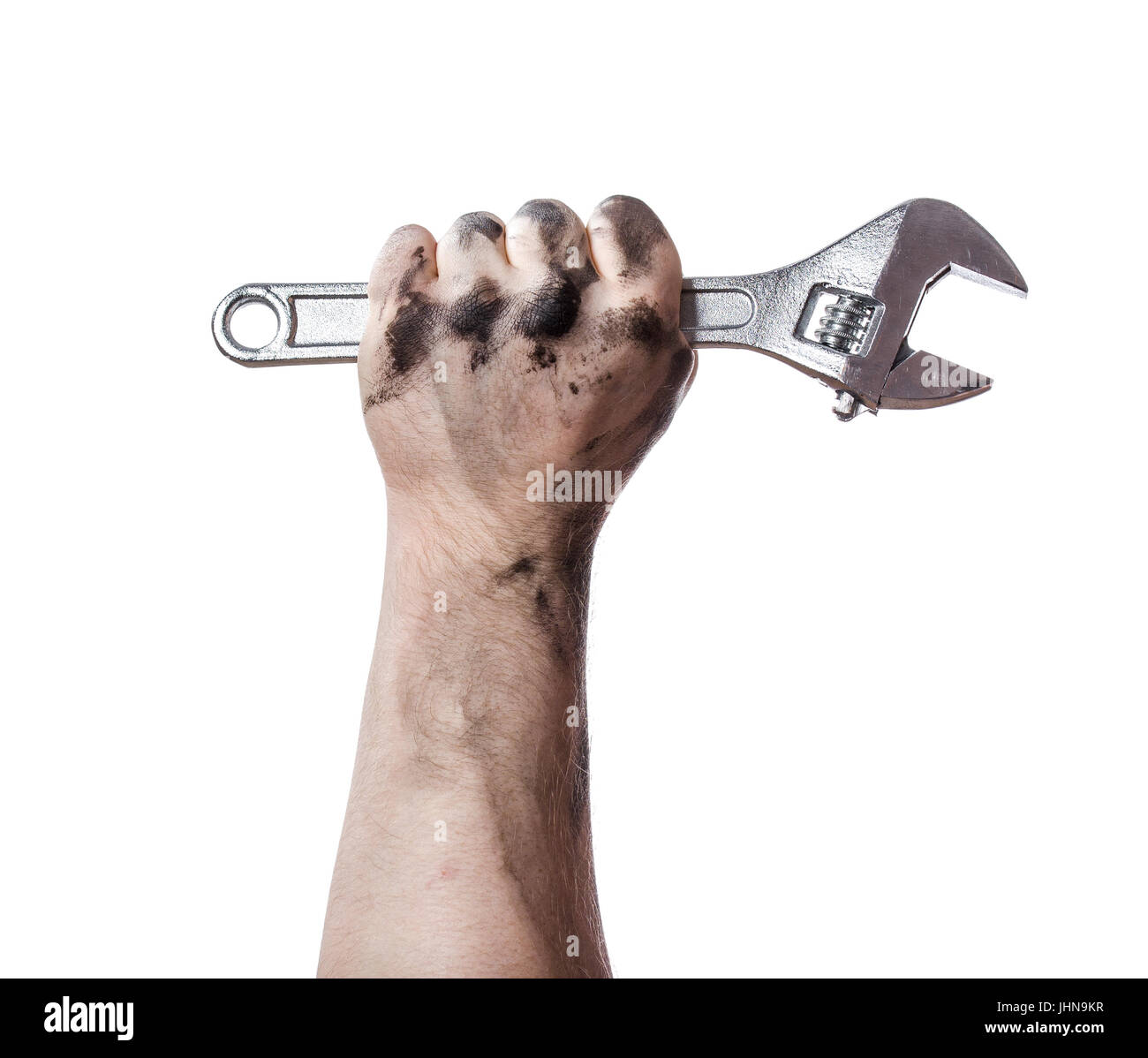 Oily hands of mechanic holding a wrench. Isolated background. Stock Photo