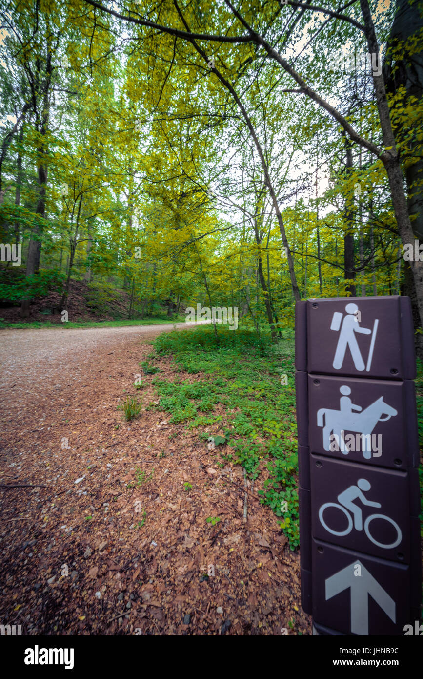 Sign on a hiking trail in Philadelphia through woodland with an arrow