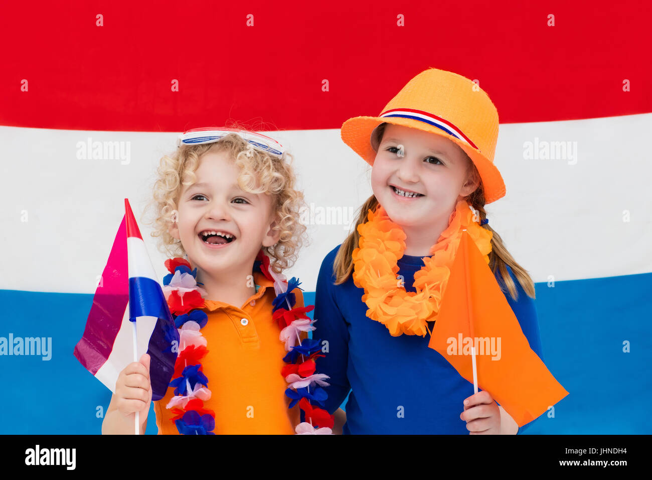 Little Dutch boy and girl wearing country symbols celebrating King day. Children support Holland sport team. Kids from the Netherlands. Young sport fa Stock Photo