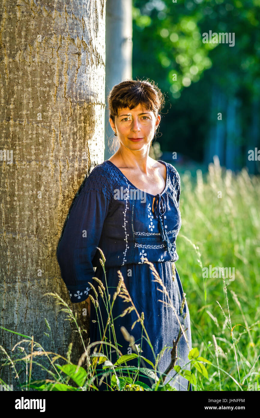 Beauty woman portrait in the summer forest, sunset Stock Photo - Alamy