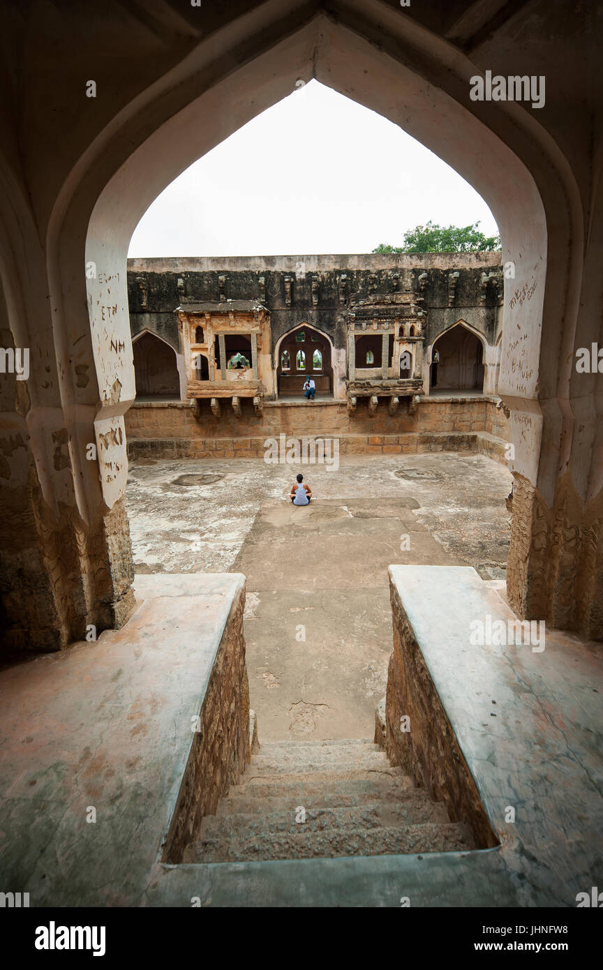 Tourist siting at the Queen's Bath Palace, Hampi, Karnataka, India Stock Photo