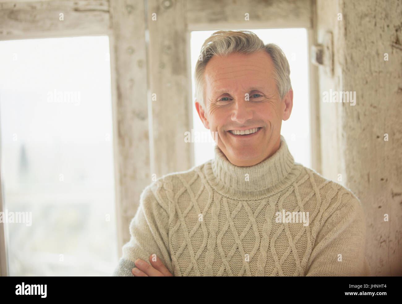 Portrait smiling senior man in turtleneck sweater Stock Photo