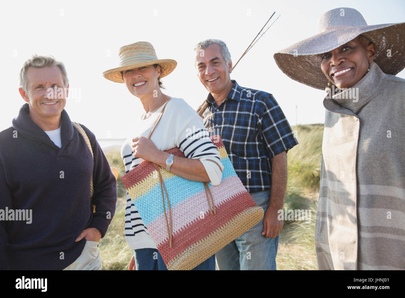 Portrait smiling mature couples on sunny beach Stock Photo