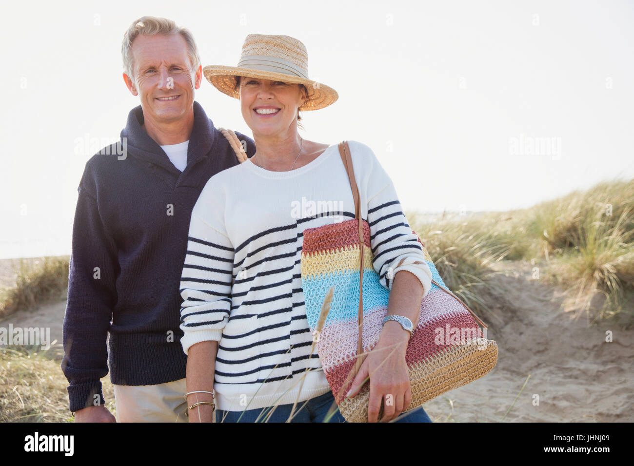 Portrait smiling mature couple on sunny beach Stock Photo