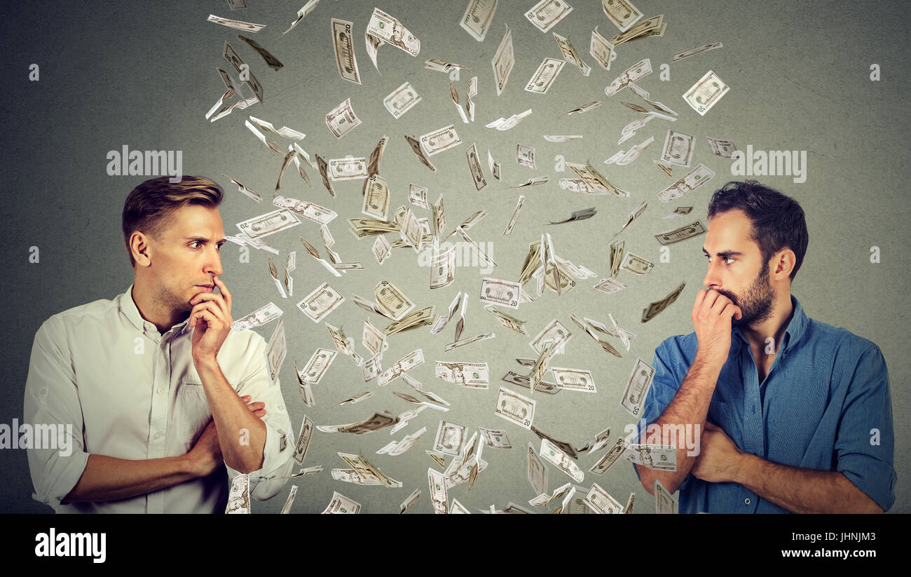 Side profile of two serious businessmen looking at each other with ...
