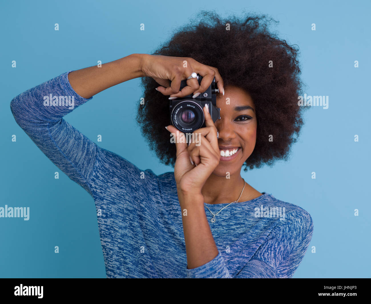 portrait of a smiling pretty african american girl taking photo on a ...