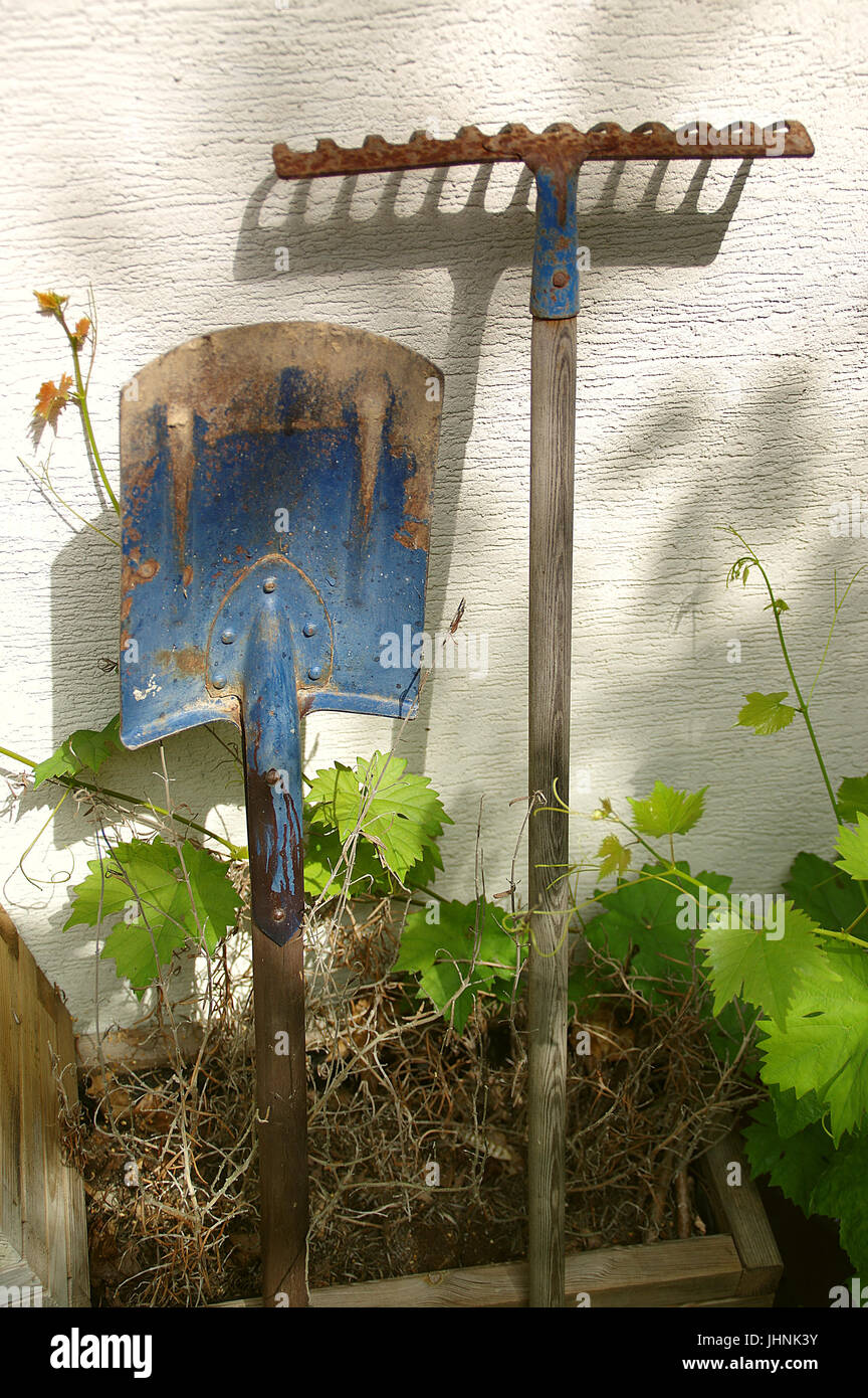 Old garden tools. Rusty shovel and rake Stock Photo Alamy