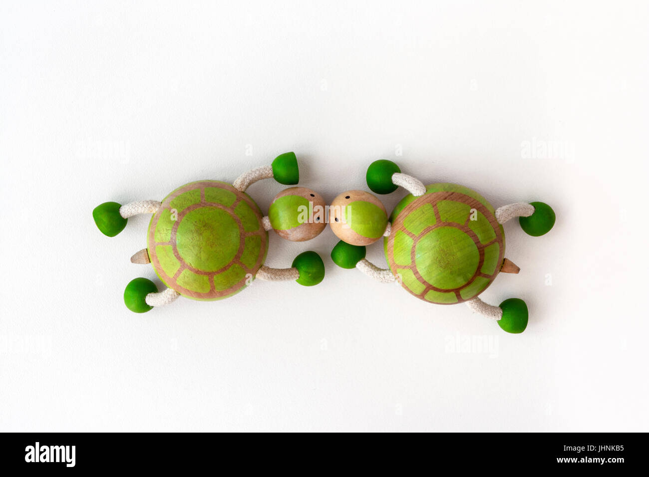 Wooden toy turtles kissing. Romantic turtle background Stock Photo