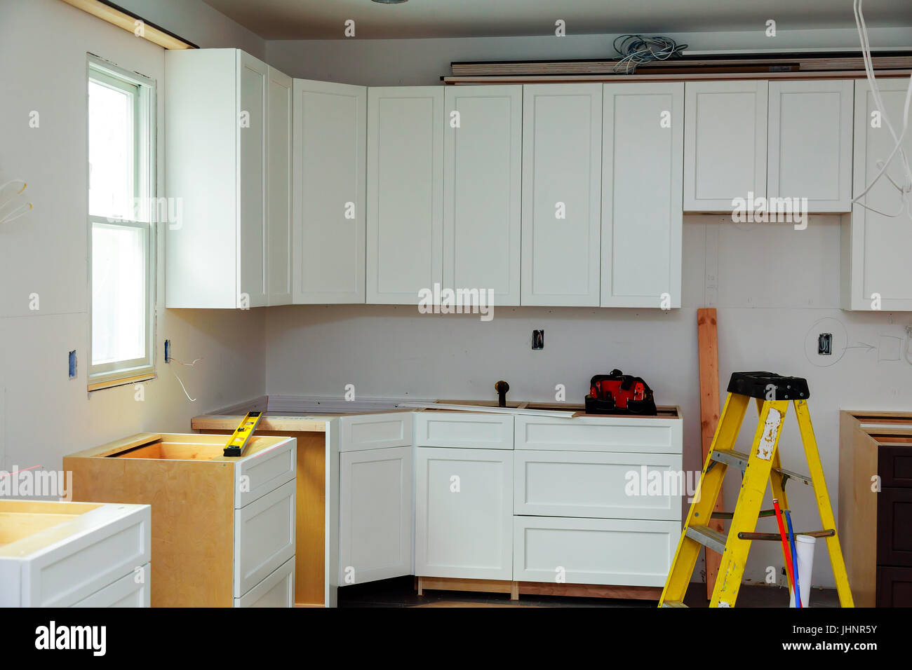 Custom kitchen in various stages of installation base for island in center Installation