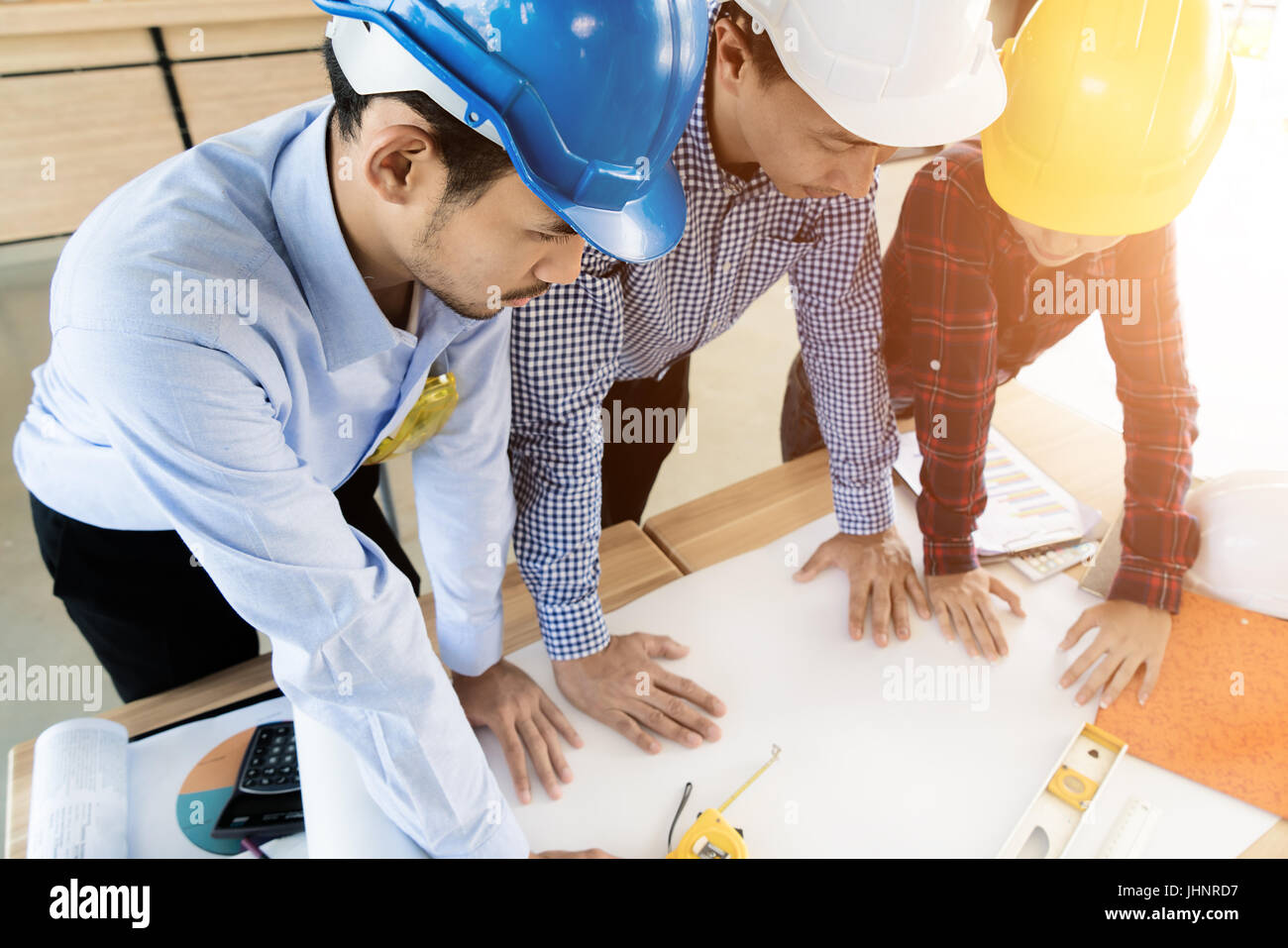 Asian engineer or architect meeting for architectural project. working with partner and engineering tools on workplace. Engineer or architect meeting  Stock Photo