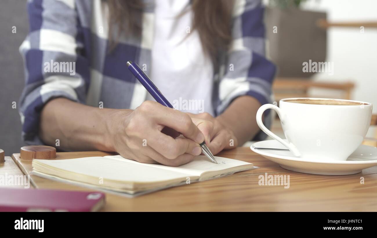 Close Up Of A Woman Sitting And Writing In Her Journal Stock Photo Alamy