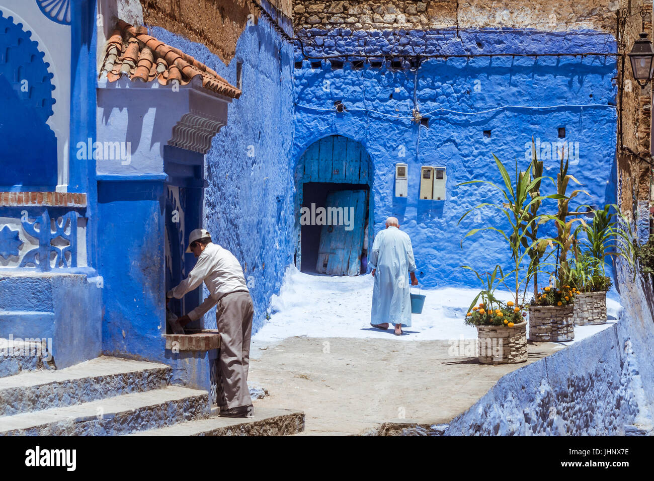 Chefchaouen, Morocco, July 18, 2015 : Moroccan people near a fountain in the medina of Chefchaouen, North of Morocco. Stock Photo