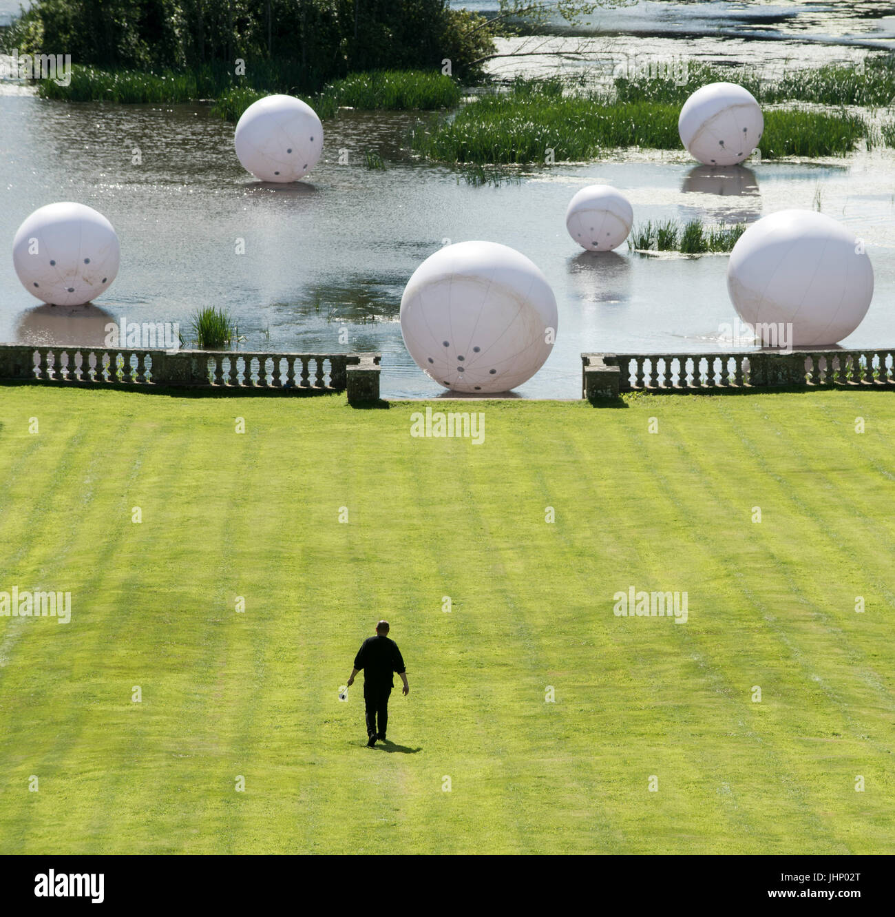 Friday 14th of July 2017: Mellerstain House, Kelso, Scottish Borders. Artist Steve Messam launches the opening of the Borders Sculpture Park with three installations in the grounds of Mellerstain House in the Scottish Borders. Spiked, Scatter and Towered.   On the lake at the foot of the lawn a collection of pure white spheres float on the surface of the water. ‘Scatter’ is a series of spheres which disrupt the wide open space of the water and play with its scale, surface and light. The balls, at a variety of sizes from 1m to 4m diameter bring a sense of scale to the landscape. The pieces appe Stock Photo