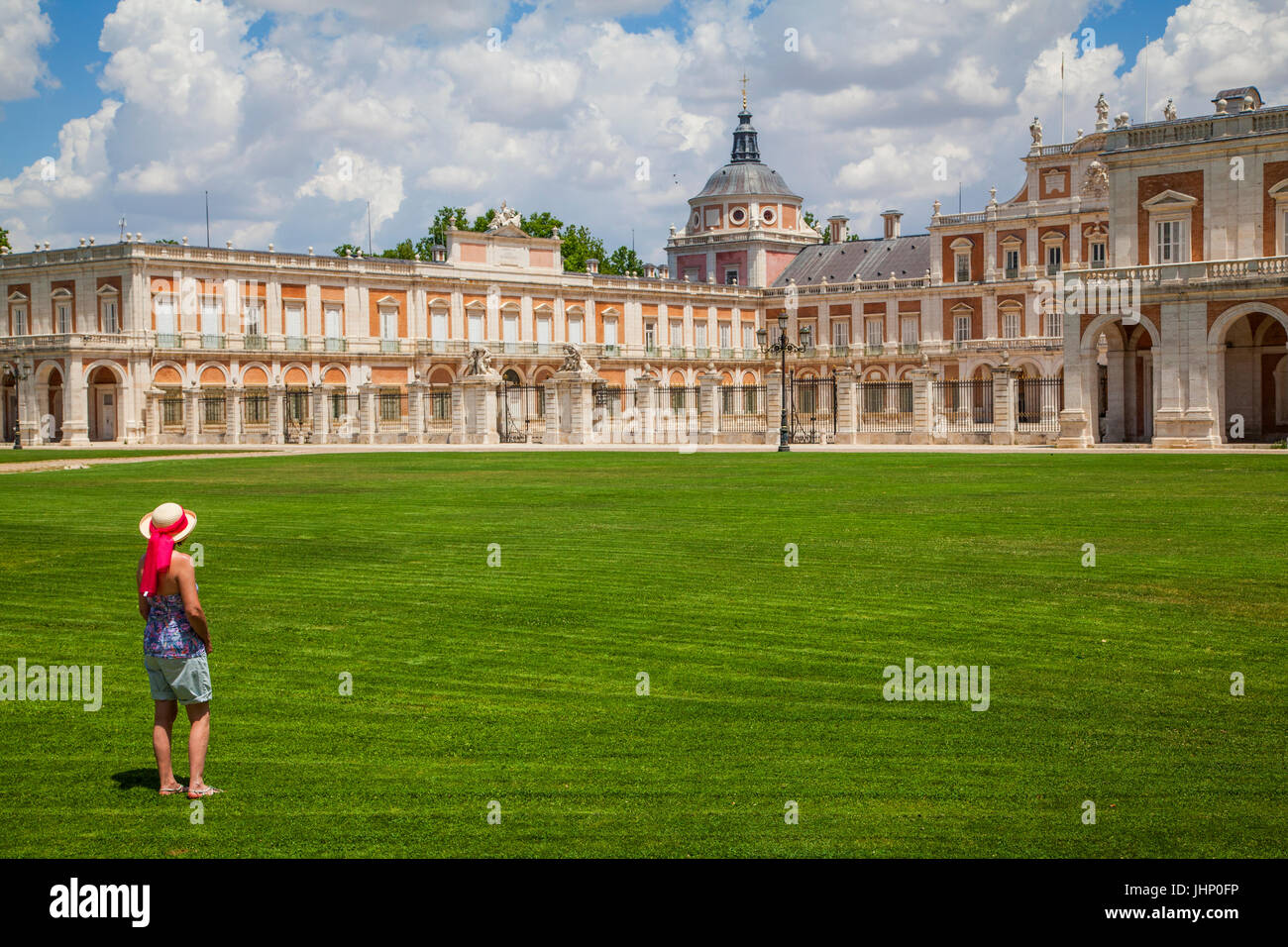 Woman looking at the the Royal Palace of Aranjuez which  is the spring residence of the Spanish Royal Family Stock Photo