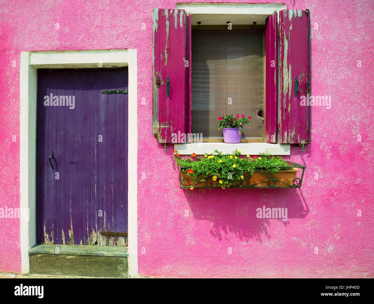 Burano, Venice/ The small yard with bright pink walls of houses Stock Photo
