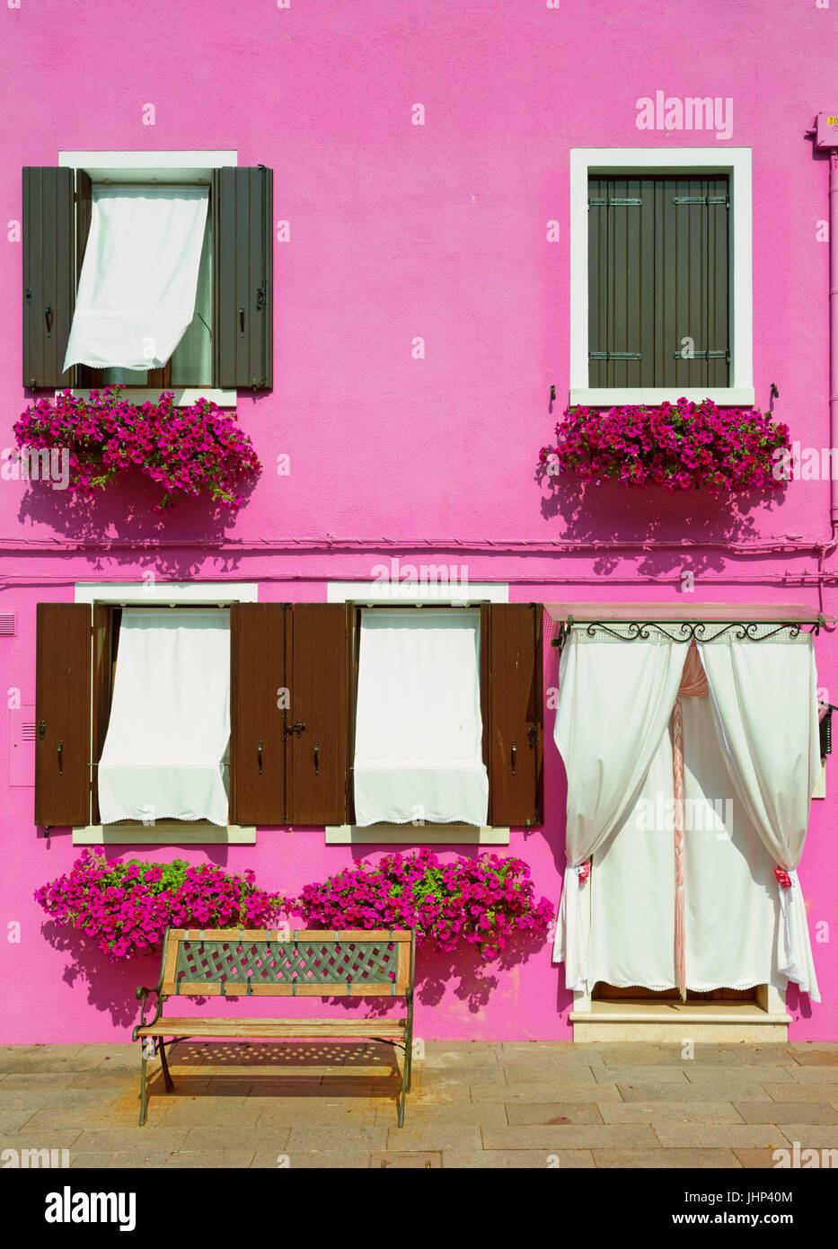 Burano, Venice/ The small yard with bright pink walls of houses Stock Photo
