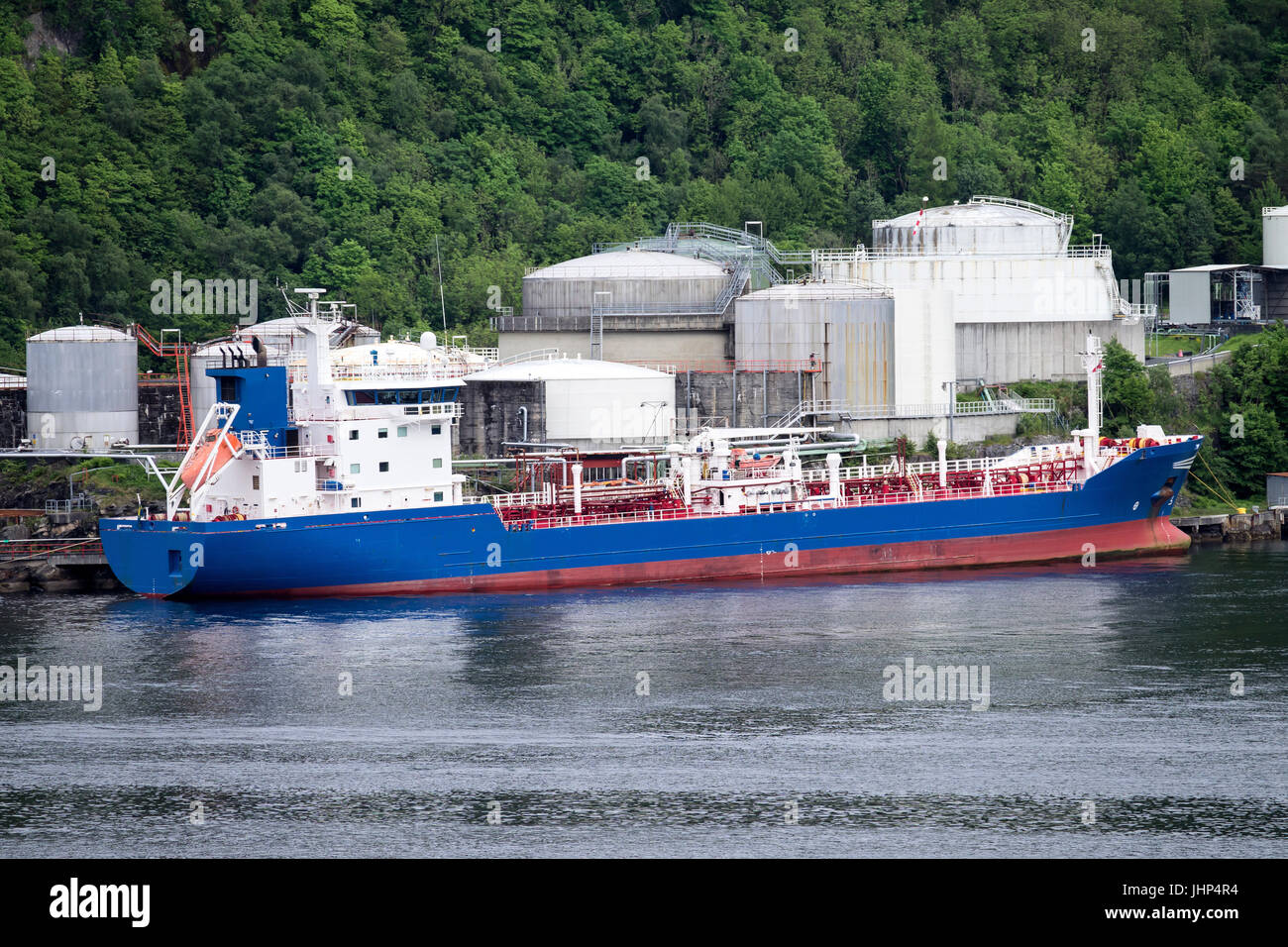 double hull oil and chemical tanker at oil depot in Norwegian fjord