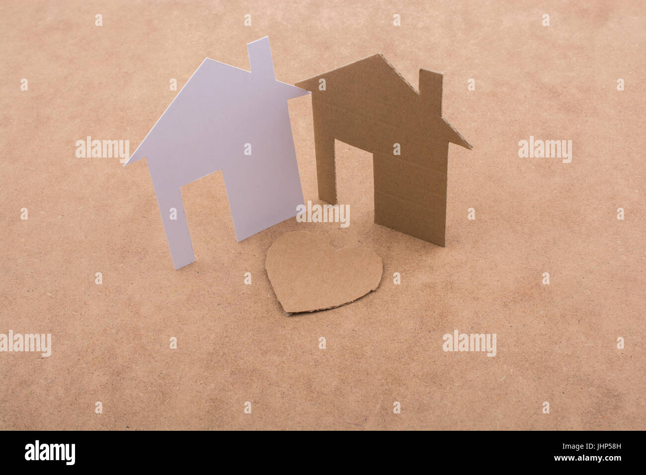 Heart shaped icon and paper houses on a brown background Stock Photo ...