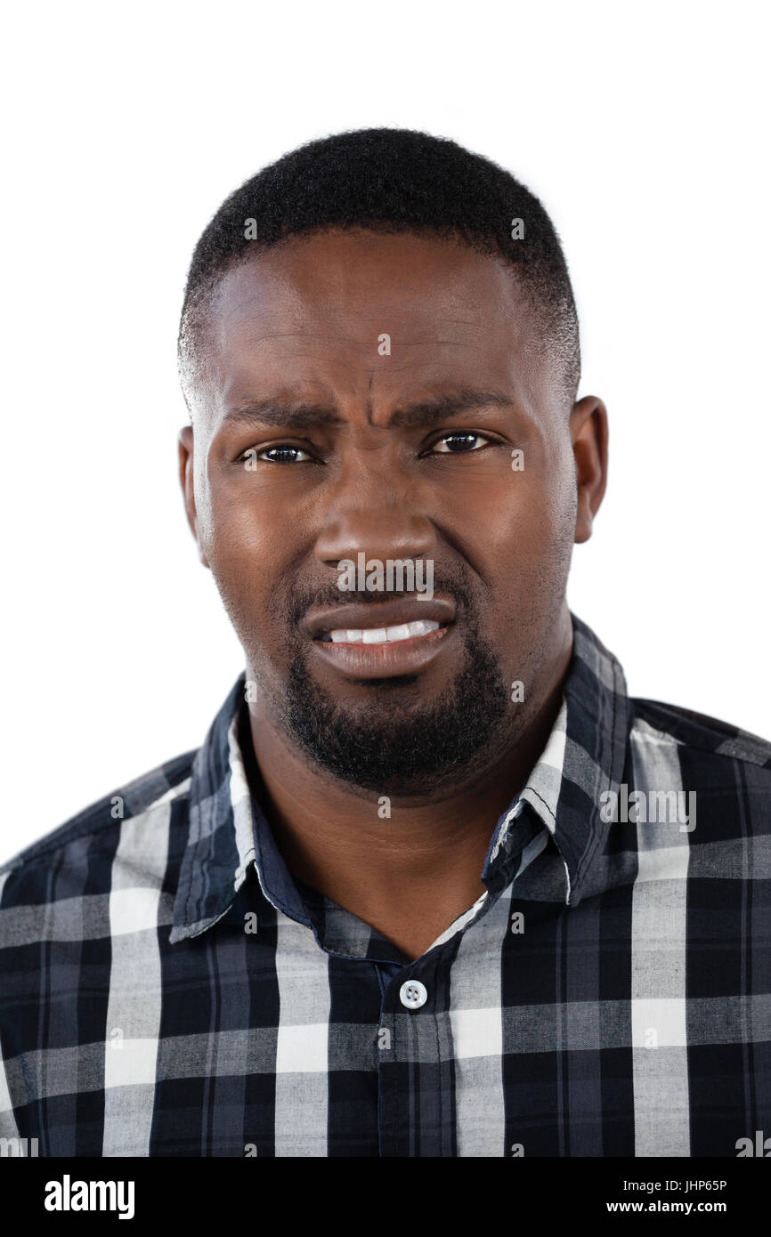 Portrait of confused man against white background Stock Photo - Alamy
