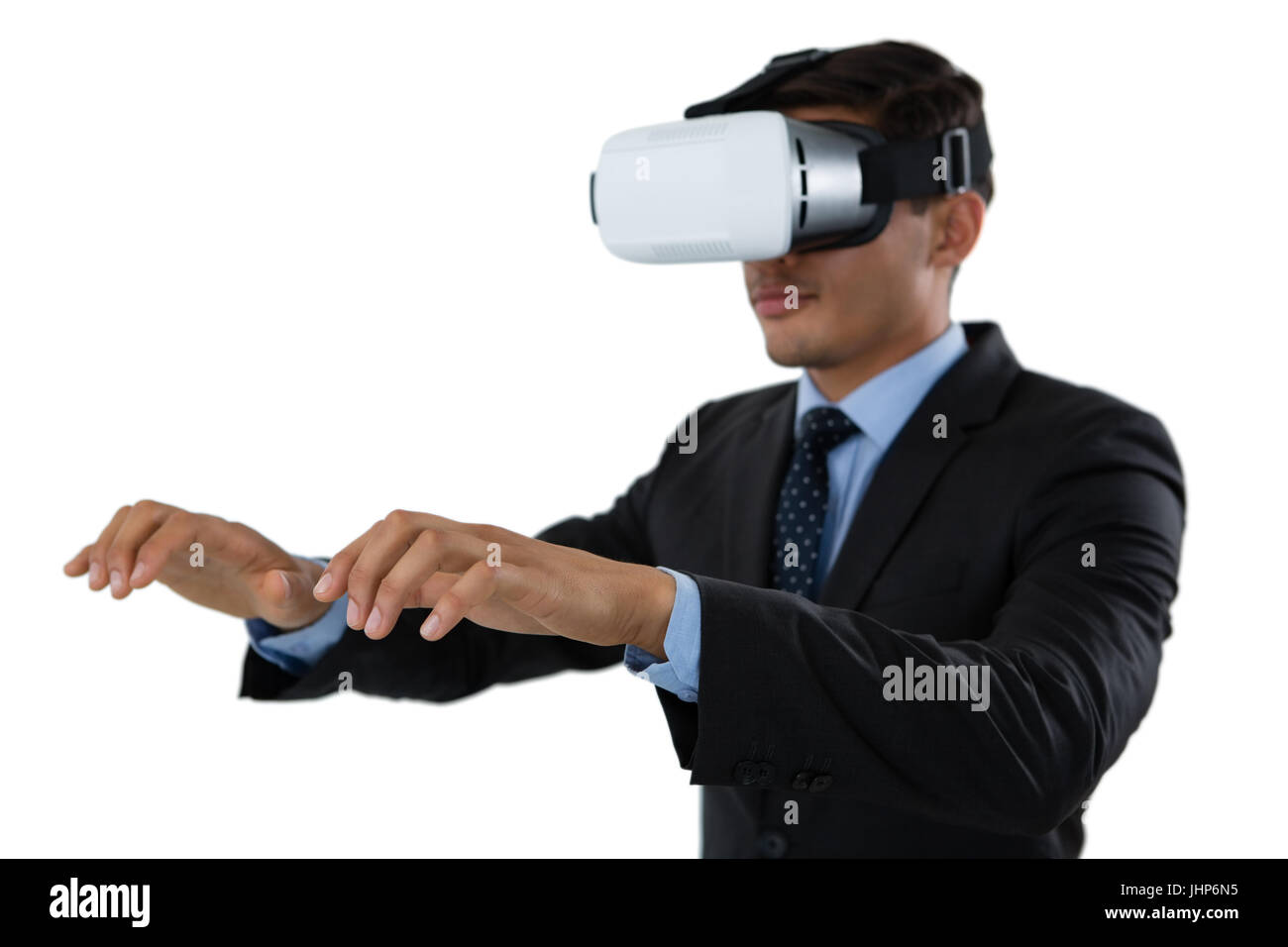 Young businessman gesturing while wearing vr glasses against white background Stock Photo