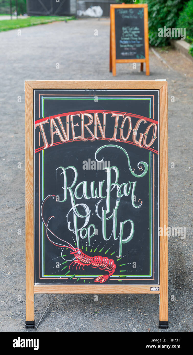 a sandwich board advertising a raw bar at tavern on the green in new york city's central park, ny Stock Photo