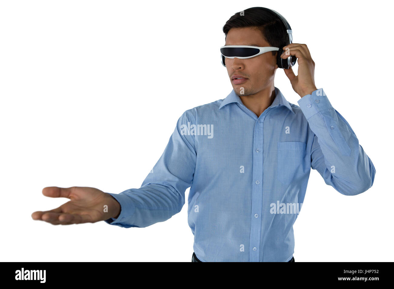 Young businessman using smart glasses while standing against white background Stock Photo