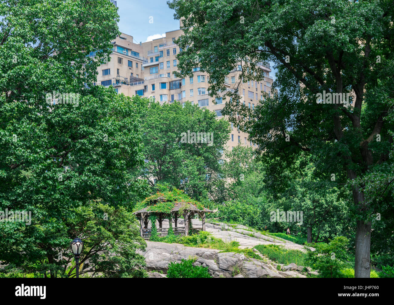 small crude structure in central park with high rise buidings in the distance in NYC. Stock Photo