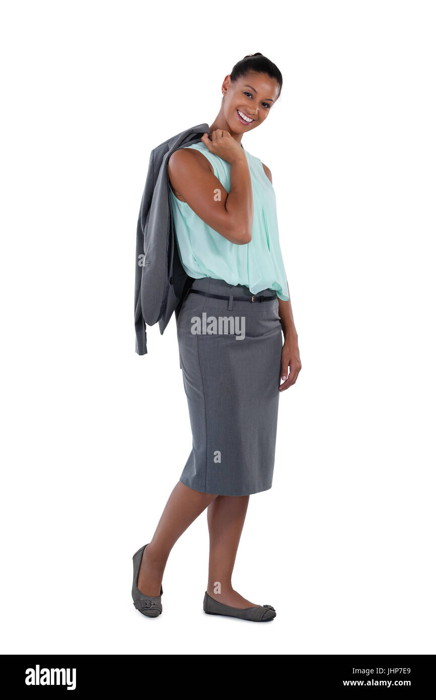 Portrait of businesswoman holding blazer against white background Stock ...