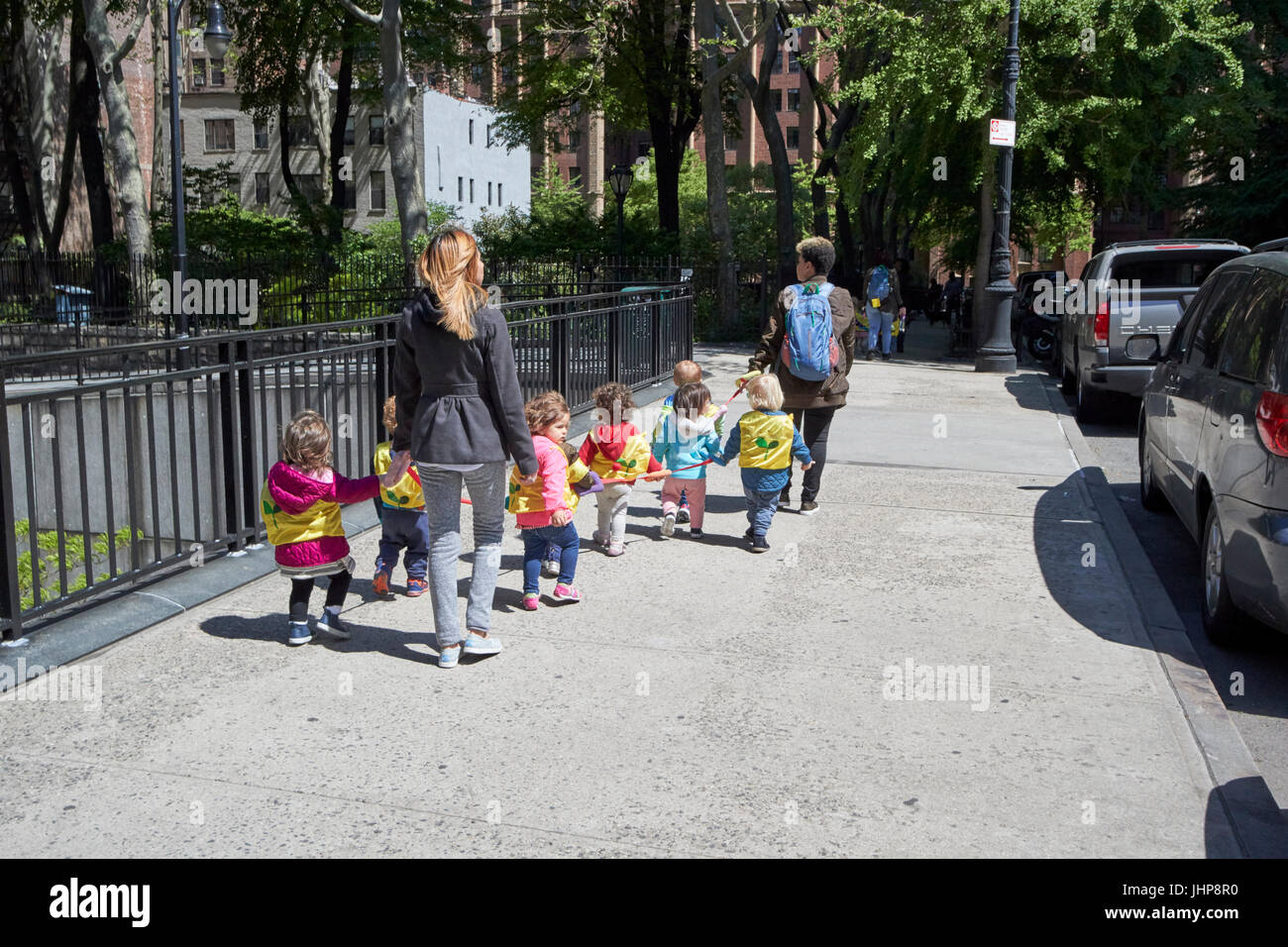 women walking preschool children on walking rope tudor city new york city  usa Stock Photo - Alamy