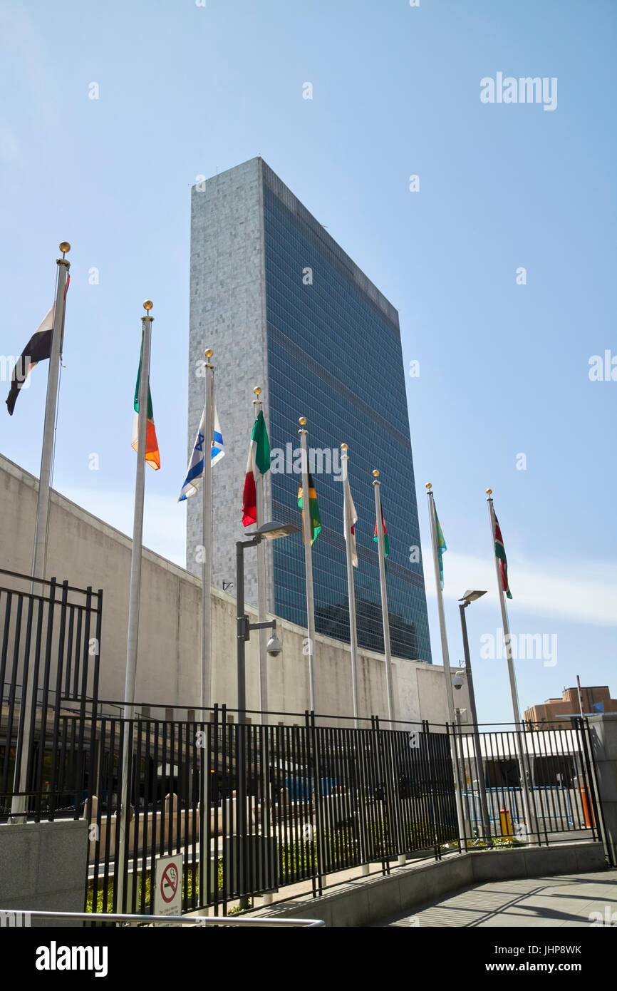 flags flying outside the UN secretariat tower building united nations New York City USA Stock Photo